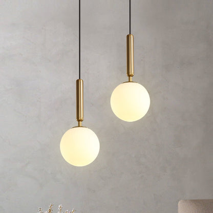 Hanging lamp in the shape of a golden glass ball